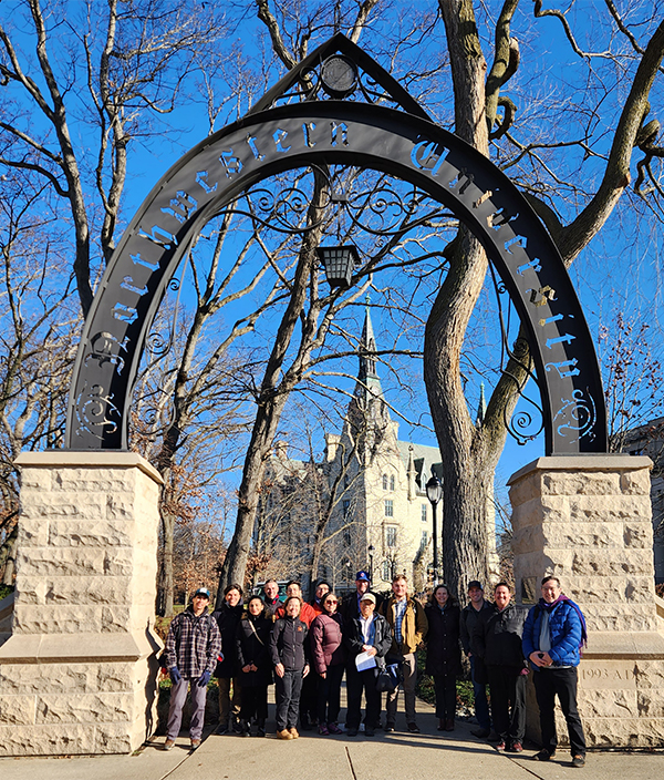 Workshop participants under the NU arch